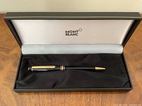 Pen seated in open Montblanc presentation box showing logo on interior lid and fabric lining
