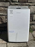 Front view of NOMA dehumidifier showing branding and water tank section.