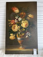 Full view of signed oil painting of a bouquet in urn with vibrant flowers on dark background.