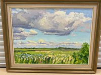 Frontal view of entire framed painting showing landscape scene and frame