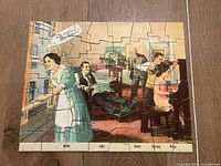 Photo shows the complete assembled jigsaw puzzle portraying a scene from "The Goldbergs" with characters named Mollie, Jake, David, Sammy, and Rosie in a living room.