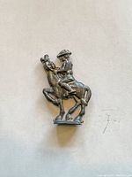 Close-up photo of lead cavalry soldier on horseback figure showing handcrafted detail, soldier wearing a hat sitting on a rearing horse.