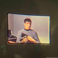 Mounted slide showing Spock holding a device