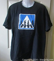 Full frontal view of black Beatles Abbey Road t-shirt on mannequin showing the graphic design.