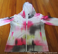 Front view of the Bench multicolor hoodie laid flat, showing ombre pattern, full front zipper, slit pockets, and thumbhole cuffs.