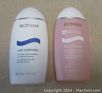Photo of two Biotherm bottles: white Lait Corporel and pink Biosource bottles side by side.