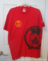 Red Canadian Pacific Railway T-shirt hanging on wooden hanger against white door, showing front with large graphic logo including buffalo, maple leaf, and 1881 date