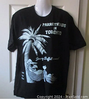 Front of the black T-shirt with white graphic of parrot with cocktail on palm tree and CN Tower, 'Parrotheads in Toronto' text.
