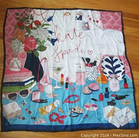 Top view of colorful square silk scarf with Kate Spade Party Time design, showing detailed illustrations of makeup, flowers, and accessories.