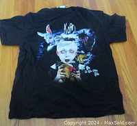 Full front view of black Korn See You On the Other Side tour T-shirt showing full color graphic with child, rabbit, horse figure and Korn logo.