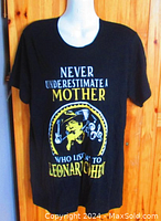 Front view of black Leonard Cohen T-shirt on a mannequin showing graphic and text.