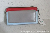 Front of Soruka leather wallet showing red, gray, baby blue colors with tag attached