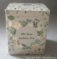 Front angle view of the Yves Rocher Thé Doré Golden Tea candle box showing decorative botanical design and golden foil branding.