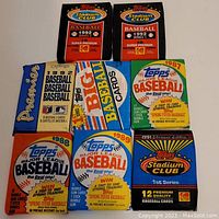 Front view showing 8 different unopened Topps baseball card packs from years 1987 to 1992 including Stadium Club and 1st Series.