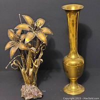 Photo showing the brass flowers with yellow-tinted petals alongside the tall brass vase.