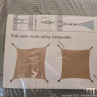 Instruction label showing the installation method using turnbuckles to fully open and secure the shade sail.