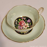 Top view of Paragon fine bone china cup and saucer showing floral design and gold trim