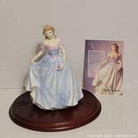 Royal Doulton Faith figurine on wooden stand with informational card