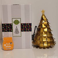 Photo showing Scentsy Treetops Glisten tin warmer, Rise & Sunshine scent bar and original box.