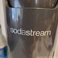 Close-up photo showing the SodaStream brand name on the black soda maker machine.