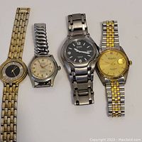 Four watches displayed showing various brands including Beni, LeRoy, Citizen, and Dufonte with bracelets and faces visible.