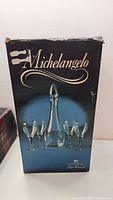 Photo of original packaging showing set includes one decanter and four wine glasses