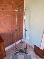 Front view of metal art display easel with decorative scrollwork and adjustable fittings.