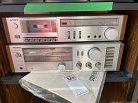 Front view showing both Sony stereo units stacked: the TC-K22 cassette player on top and the STR-V25 receiver below, both in a vintage silver finish.