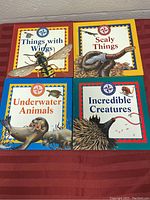 Top-down photo showing all four children's educational books by The Nature Company with colorful covers and animal illustrations.