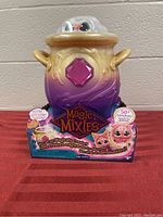 Front view of Magic Mixies Magic Cauldron toy in original box with colorful packaging and product information.
