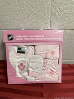 Front box view of the new in box NHL 'Take Me Home' 4-piece newborn set, showing the pink striped onesie, hat, mittens, and pants with pink Toronto Maple Leafs logos.