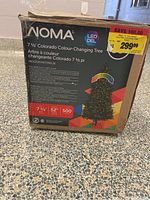 Box of the NOMA 7.5' Colorado Colour-Changing LED Christmas Tree with product details and features visible on front.