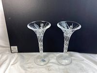 Pair of clear crystal candlestick holders viewed side by side showing overall shape and size.