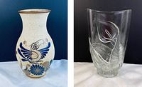 Two vases side by side showing the Mexican ceramic vase with blue and brown painted bird and floral motifs and the clear Luminarc glass vase with embossed calla lilies