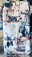 Full view of the throw blanket showing a variety of dog breeds woven in detailed tapestry style.
