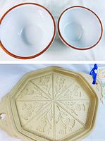 Top view of large and small terra cotta mixing bowls showing white glazed interior and brown rim.