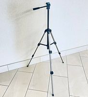 Velbon CX200 tripod fully extended and standing on tiled floor.
