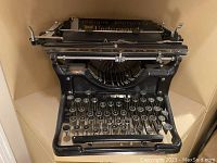 Front view of typewriter showing keyset and frame