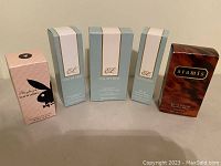 Five fragrance product boxes arranged in a row showing all brands and sizes.