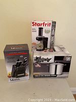 Photo showing packaging of Lagostina 14-piece knife set, Starfrit electric spiralizer, and Nutrichef stockpot together