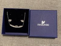 Full view of Swarovski necklace and earrings in original blue Swarovski box.