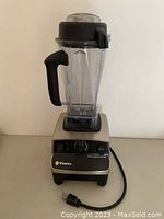 Front full view of Vitamix blender base and pitcher assembly on white background showing power cord.