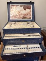Full view of the boxed bedding set with lace and ribbon decoration clearly visible.