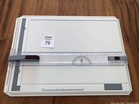 Top view of the white KOH-I-NOOR drawing board with ruler scales and sliding parallel ruler showing maxsold tag.