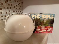 Dome-shaped carry container and original box for the Guzzini PIC BOLL picnic set