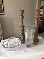 Photo showing the Mikasa crystal vase, clamshell bowl, and two carved decorative candle holders on a white cloth surface.