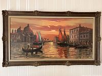 Full frontal view of the framed oil painting depicting Venice Grand Canal at sunset with gondolas and sailboats along water and the basilica in background