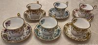 Full set of six Royal Albert Sheraton series bone china teacups and matching saucers, displaying varied floral patterns and gold trim.