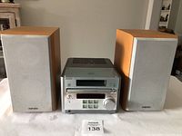 Front view of the complete Sony Micro Hi-Fi Component System CMT-RB5 showing the central CD player unit placed between two wooden speakers with fabric grills.