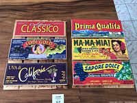 Photo of 6 folk wall art panels made from vintage wine grape crates, showing colorful retro branding and images related to California grape juice and wine.
